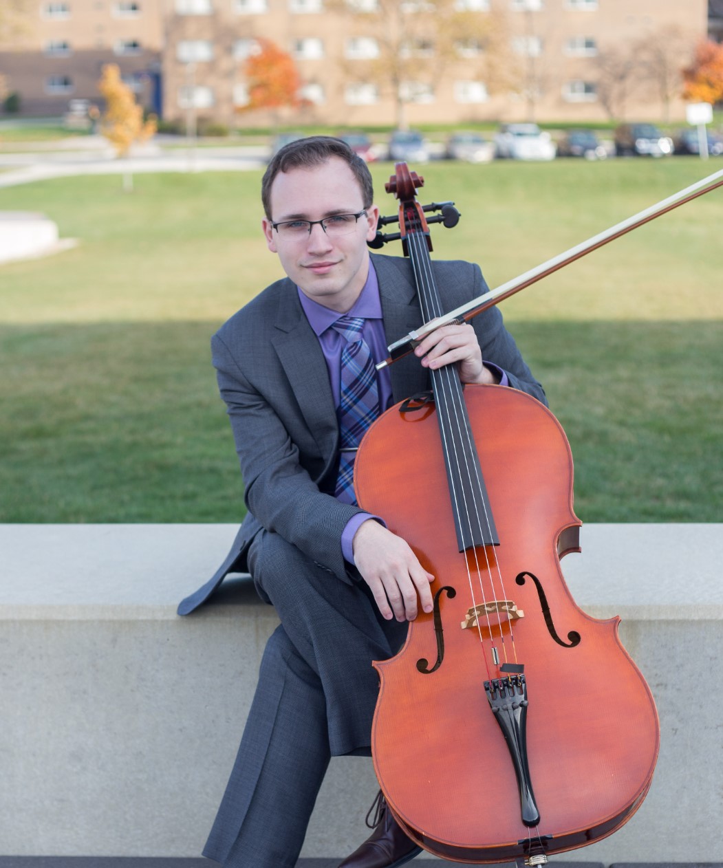 Photo of Taylor Stobinski posing with his cello